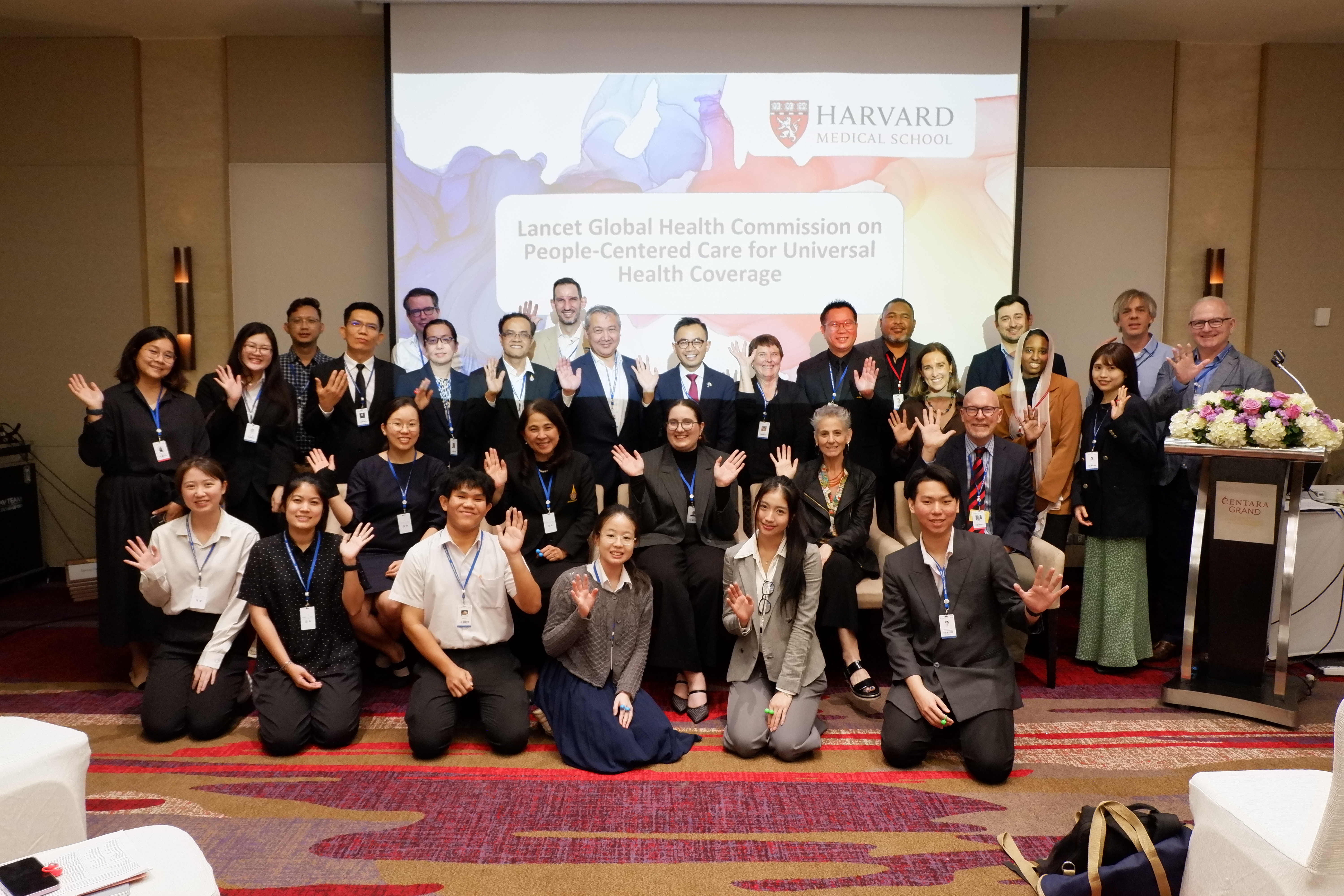 Group posing in front of the room at the PMAC event